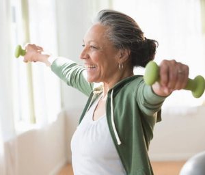 Older woman lifting hand weights