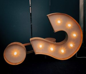 Image of a lit up question mark sign