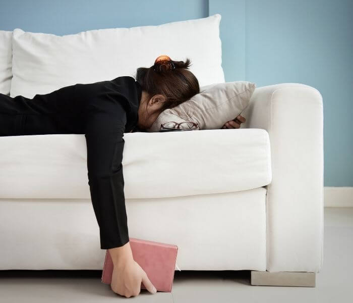 Woman laying face down on a sofa